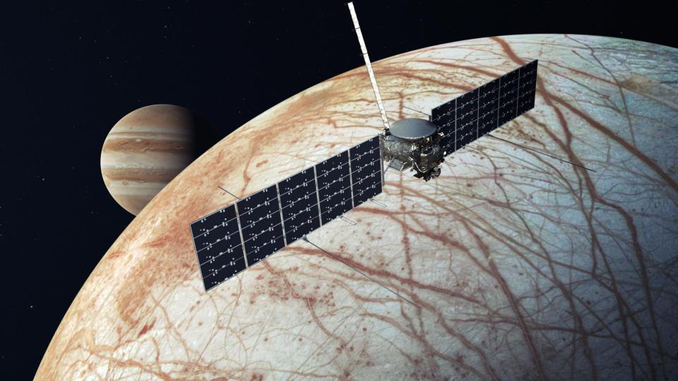 Illustration of NASA's Europa Clipper spacecraft with Jupiter and its icy moon Europa in the background (Credit: NASA/JPL-Caltech)